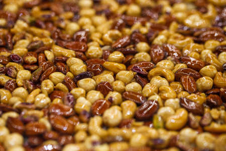 Nuts different in honey sweet syrup, selective focus.の写真素材