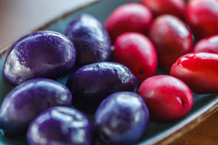 Olives colored purple and pink, selective focus.の写真素材