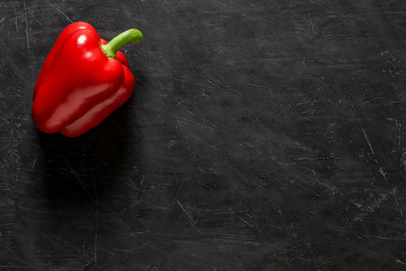 Red sweet Bulgarian pepper one whole on dark background, top view, space to copy text.の写真素材