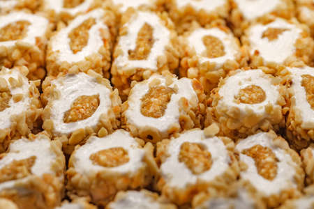Baklava with peanuts and white cream, in bulk, selective focus.の写真素材