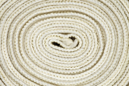 Elastic bandage twisted into coil in spiral close-up full depth of fieldの写真素材