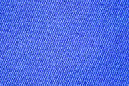 Background of blue fabric close-up, uniform textureの写真素材