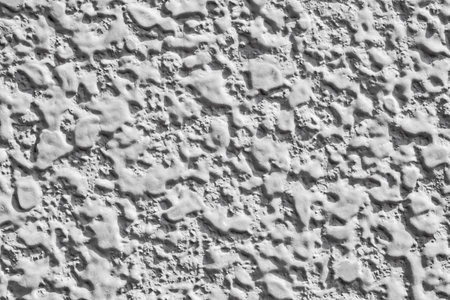 Background wall covered with drip stains of cement white mortar, close-up, uniform texture