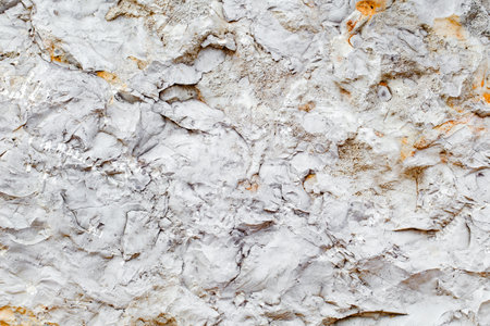 Background stone chipped surface uneven, uniform texture gray orangeの写真素材