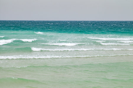Storm waves at sea in cloudy weather, blue waterの写真素材
