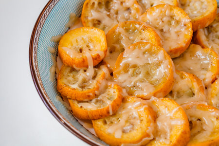 Yellow zucchini baked with grated cheese in bowl, selective focusの写真素材