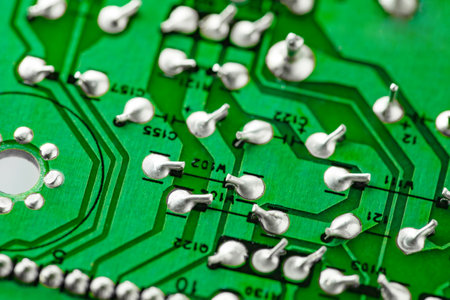 Electronic green printed circuit board with soldered contacts, close-up, selective focusの写真素材