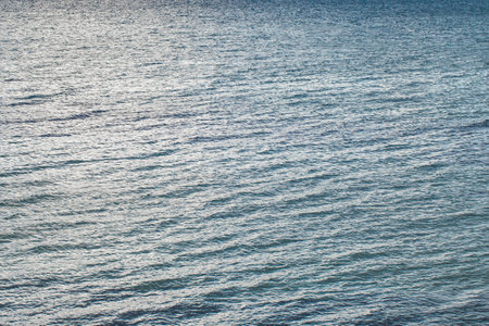 Water surface of the sea with slight waves in the evening, close-upの写真素材