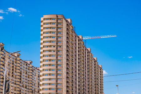 multi-storey building under construction and construction craneの写真素材