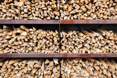 background of chopped firewood for barbecue stacked on shelves