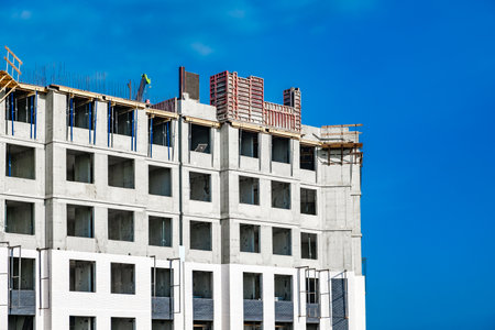 monolithic building under construction against blue sky background