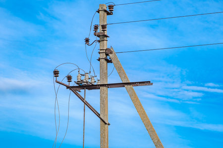 old concrete pole with broken electrical wires