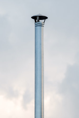 metal round chimney on the background of the sky