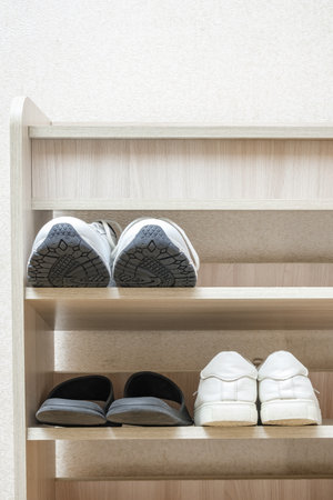 shoes sneakers and slippers on shoe rackの写真素材