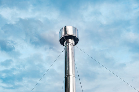 metal round chimney close-up on sky background