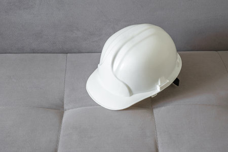 white construction helmet on the couchの写真素材