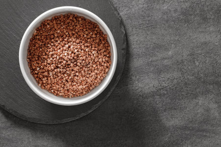 raw buckwheat groats in bowl, top viewの写真素材