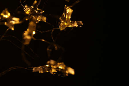 Golden lights in dark backgroundの写真素材