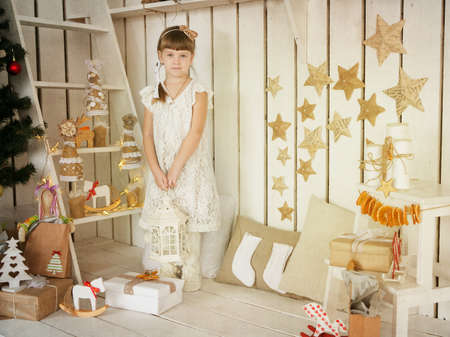 girl with a lamp in his hand standing in vintage decorationsの写真素材