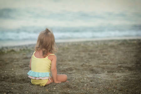 beautiful girl with Down syndrome is listening to music on headphonesの写真素材