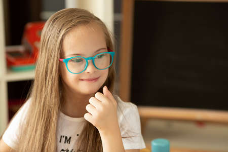 A girl with Down syndrome experiences positive emotions and joyの写真素材