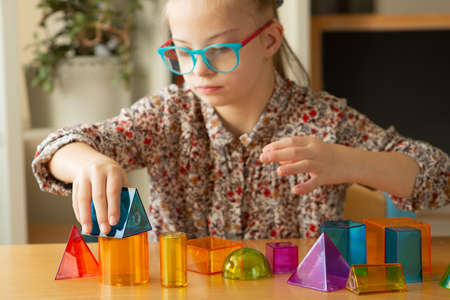 Girl with Down Syndrome studying geometric shapesの写真素材