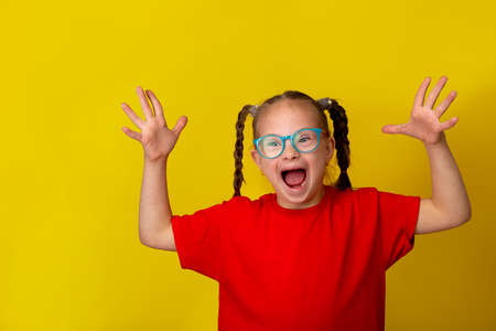Happy girl with Down syndrome having fun and laughing in the studio