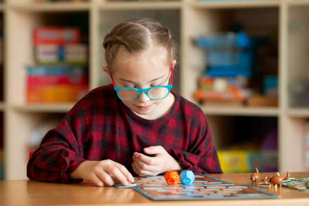 Girl with Down Syndrome Plays Board Games in Quarantineの写真素材