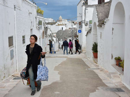 ALBEROBELLO, ITALY - FEBRUARY 11, 2019. Visiting unique houses of Alberobello, Puglia region, Italyのeditorial素材