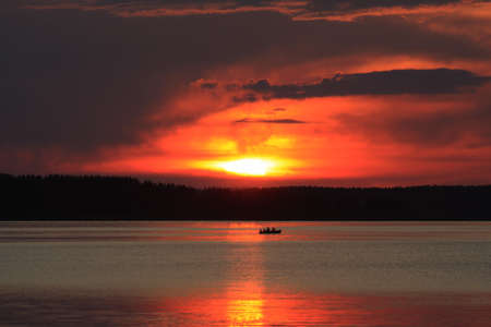 Fishing on the lake at sunsetの写真素材