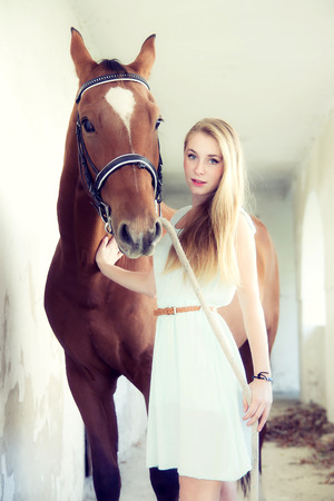 Blond woman with horseの写真素材