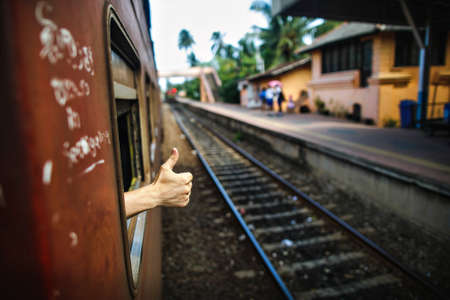 Hands showing good bye through train windowの写真素材
