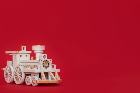 White Christmas wooden locomotive on a red background. free space. copyspace.の写真素材