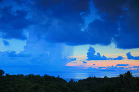 Rain and sunset under oceanの写真素材