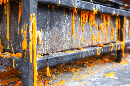 Metal shelves with melted candles placed in front of the relics