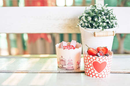 Cupcakes sweet bakery for love valentine's day. Put on a white wood floorの写真素材