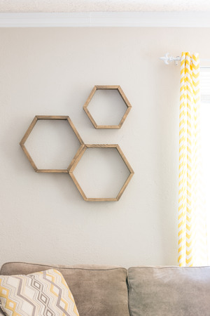Three decorative wooden, floating, hexagon wall shelves, emptyの写真素材