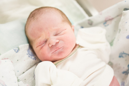 Cute newborn wearing white