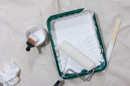 White paint, roller, brush, stir stick, pan, for painting white ceiling or trimの写真素材