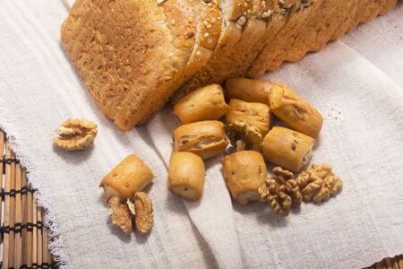 bread, hardtack and walnut on background with soft shadowの写真素材