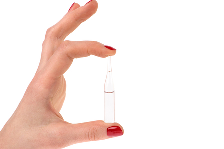 Hand holding liquid in glass ampoules (also ampul, ampule, or ampulla). Medical background.の写真素材