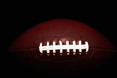 American football ball isolated on black backgroundの写真素材
