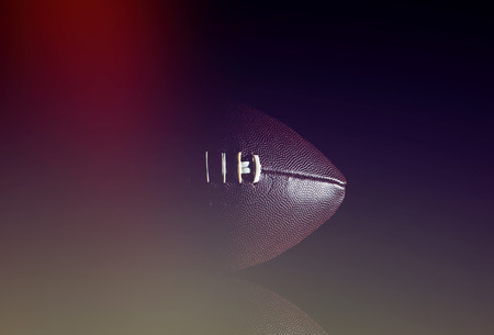 American football ball isolated on black backgroundの写真素材