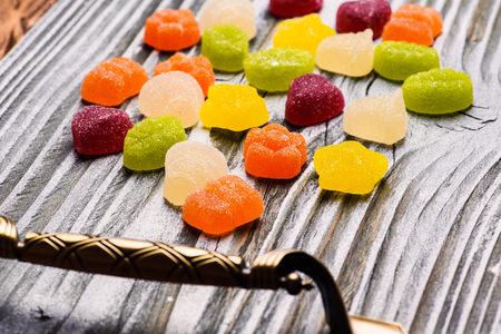 Tasty jelly candies on wooden backgroundの写真素材
