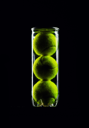 Tennis Ball isolated on black with dramatic lightingの写真素材
