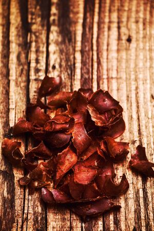 Smoked beef meat slices over rustic backgroundの写真素材