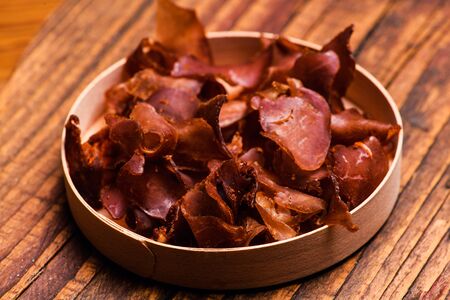 Smoked beef meat slices over rustic backgroundの写真素材