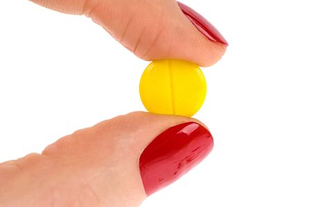 Pills in woman hand isolated on white backgroundの写真素材