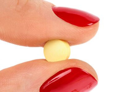 Pills in woman hand isolated on white backgroundの写真素材