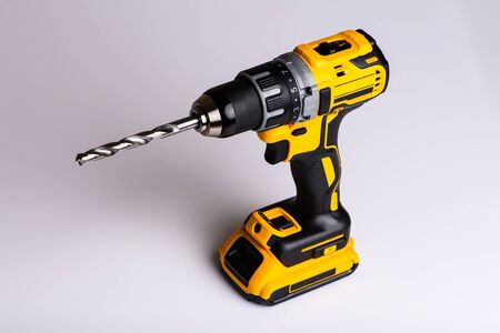 cordless drill and a drill on a white backgroundの写真素材